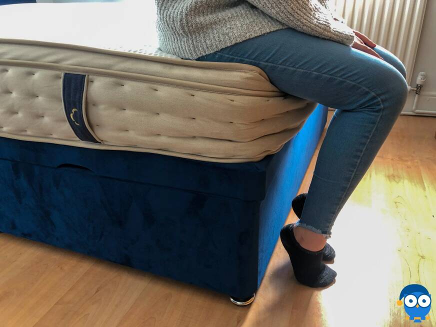 Sitting on the edge of the DreamCloud mattress.
